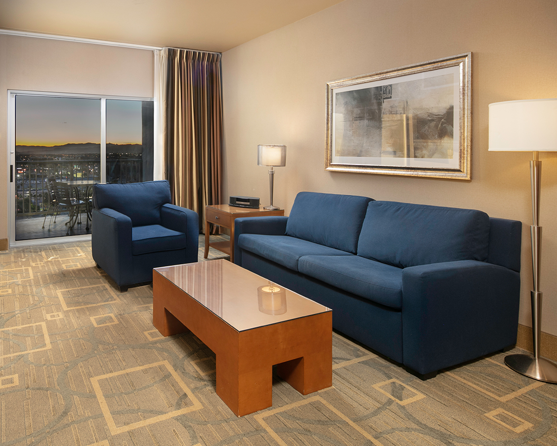 a living room with blue couches and a coffee table