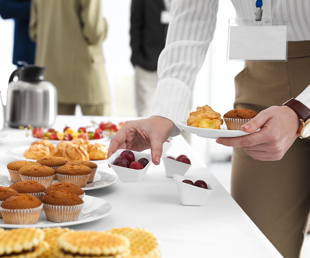 a person holding a plate of food