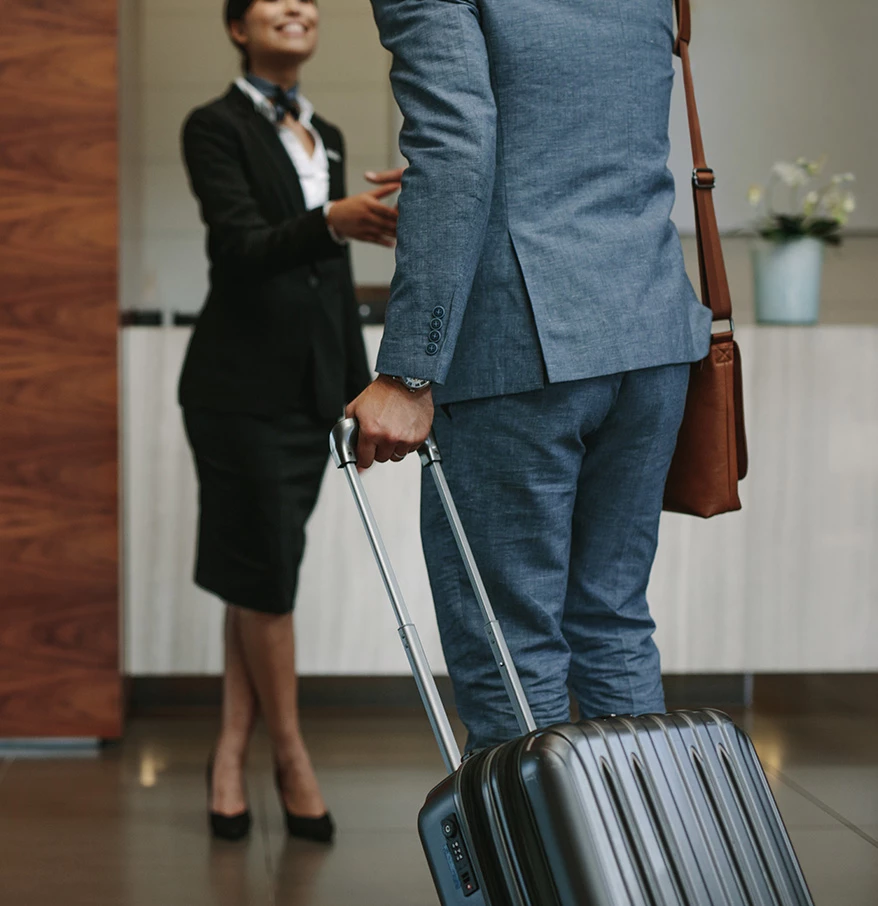 a man in suit and tie holding luggage