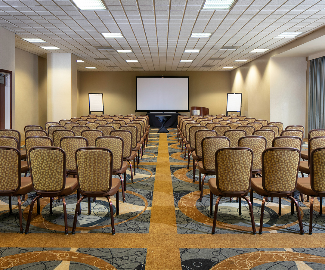 a room with chairs and a projector screen