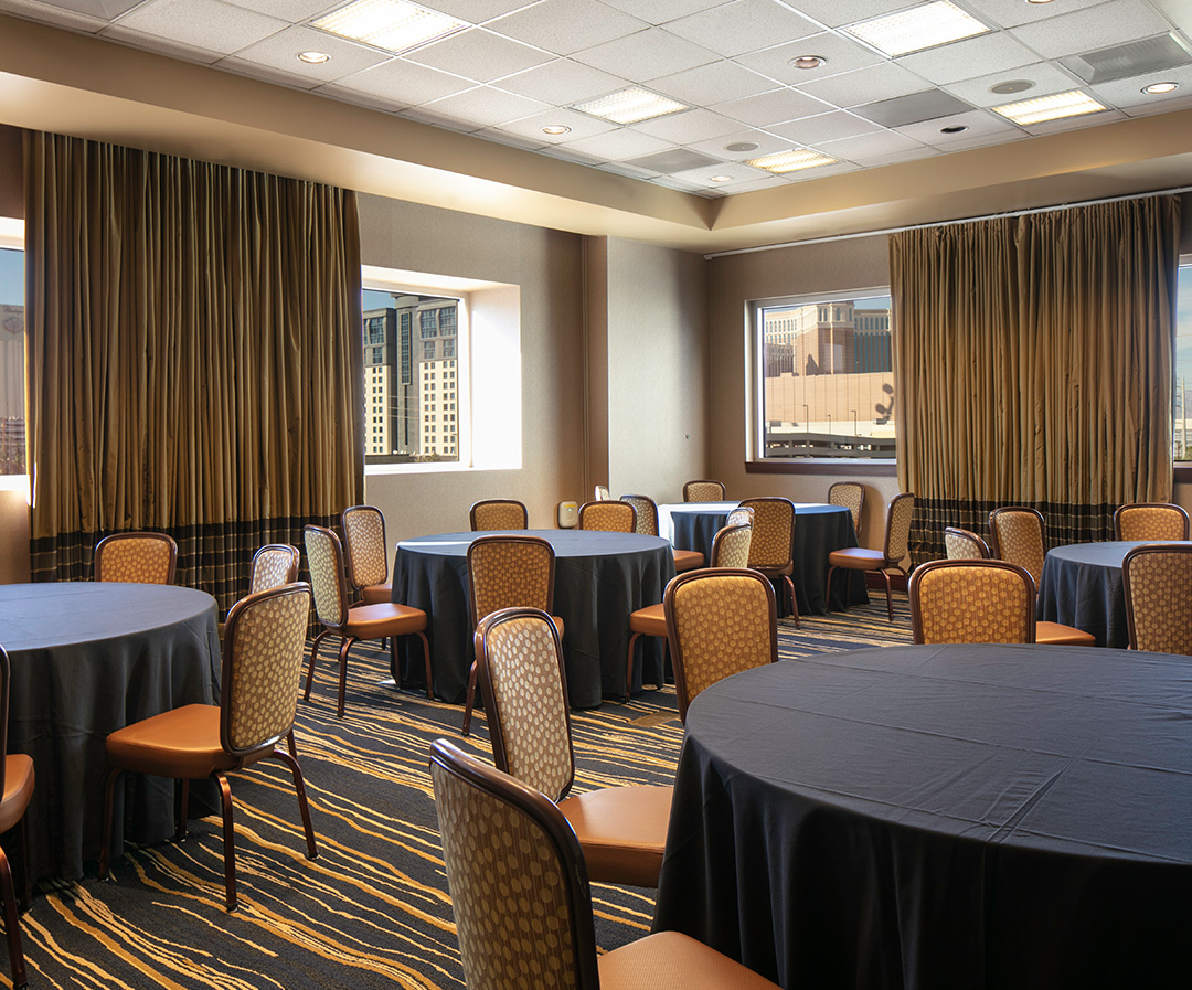 a room with round tables and chairs