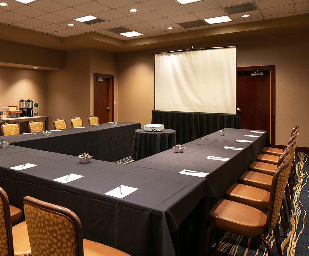 a room with a large table and chairs
