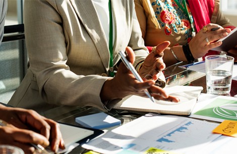 a close-up of a woman holding a pen