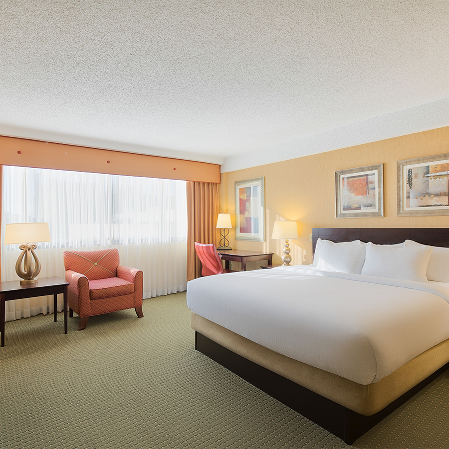 a hotel room with a bed and a chair