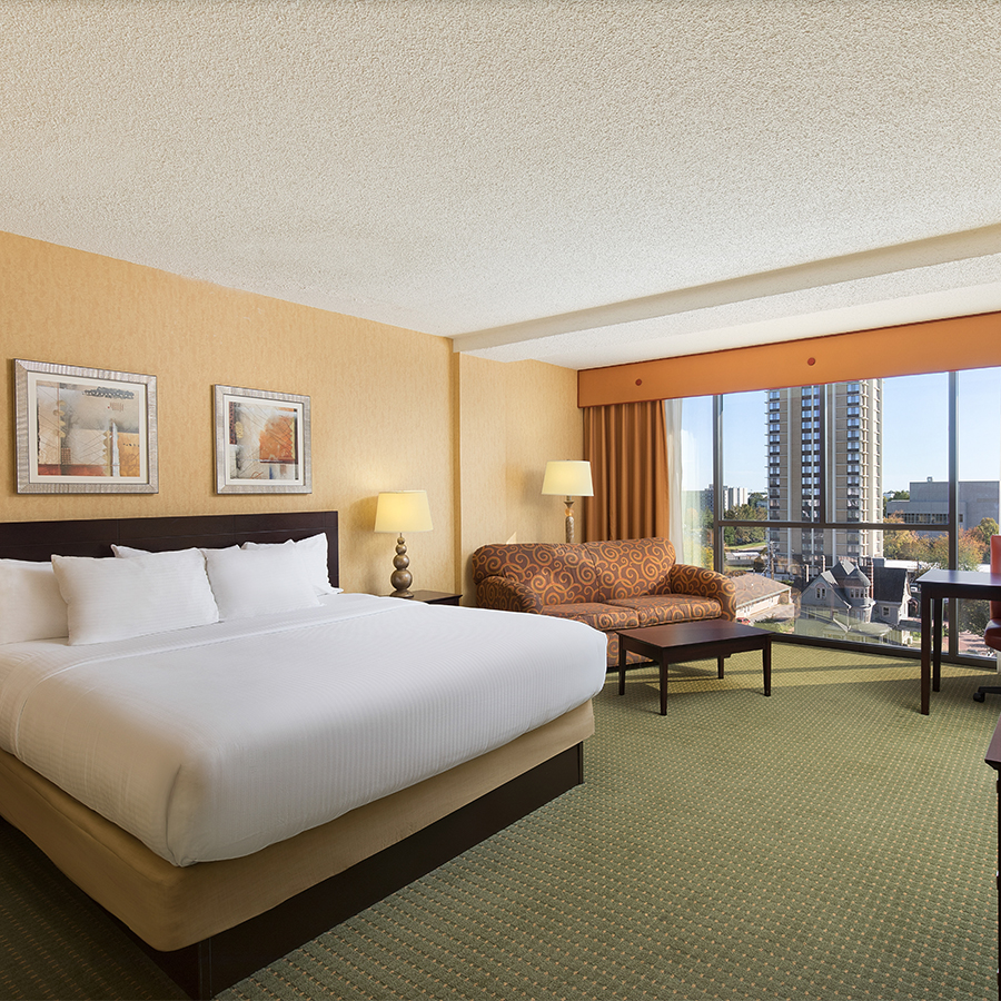 a hotel room with a bed and a couch