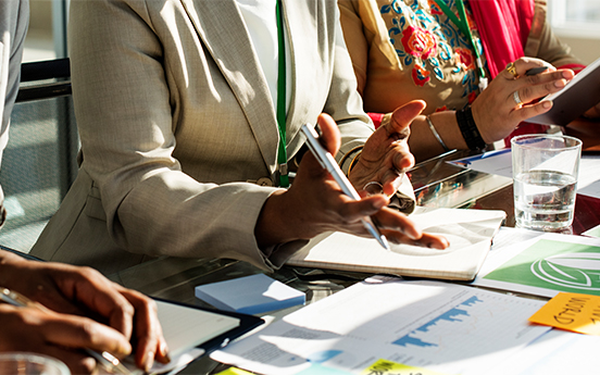 a close-up of a woman holding a pen