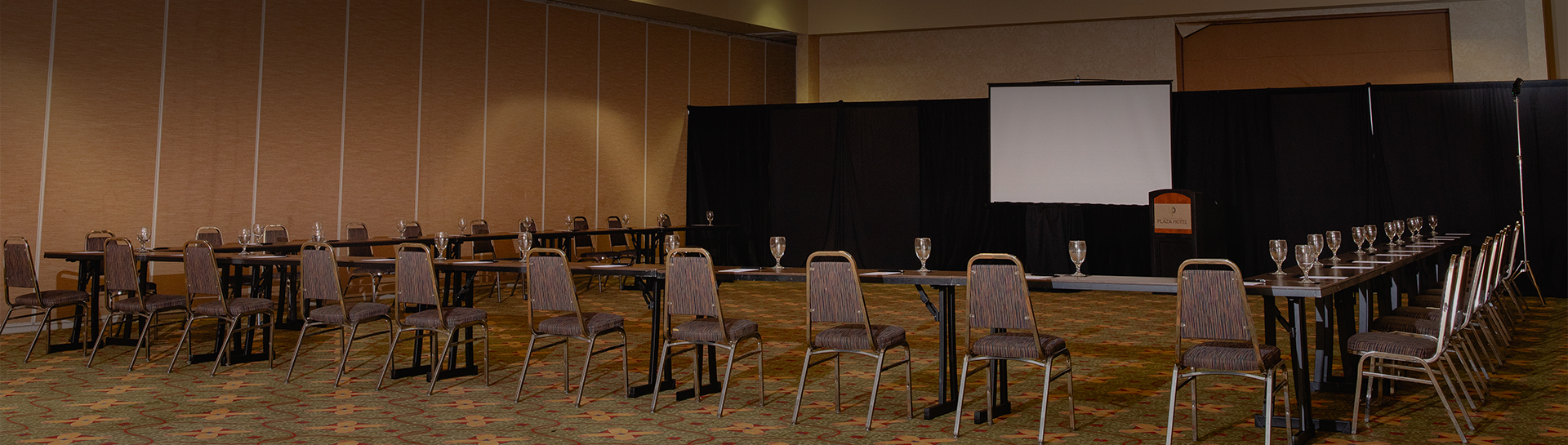 a room with chairs and a projector screen