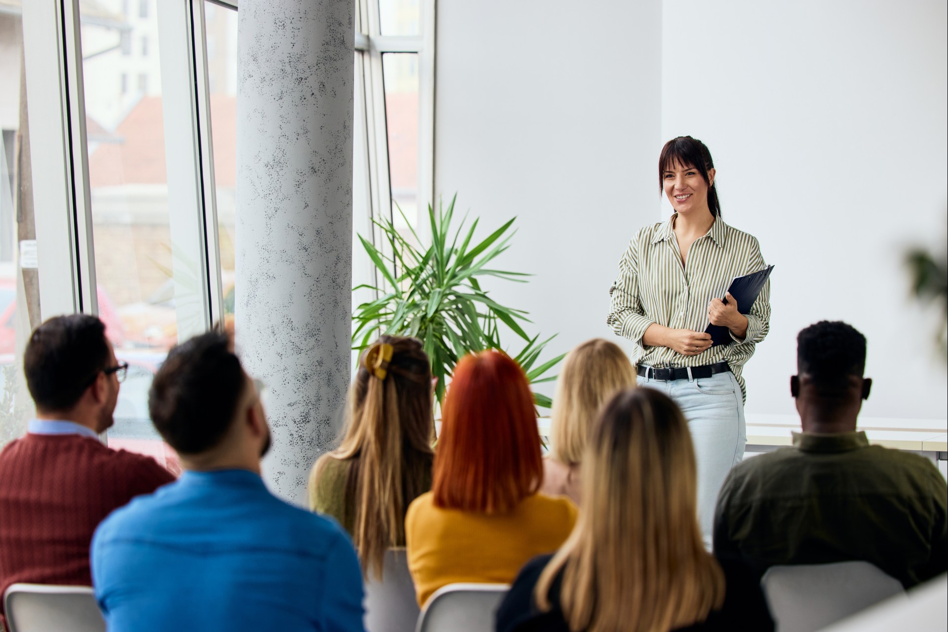 a woman standing in front of a group of people