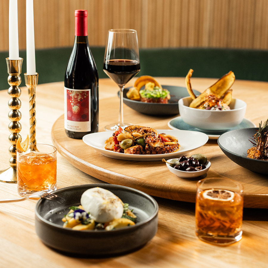 a table with plates of food and wine