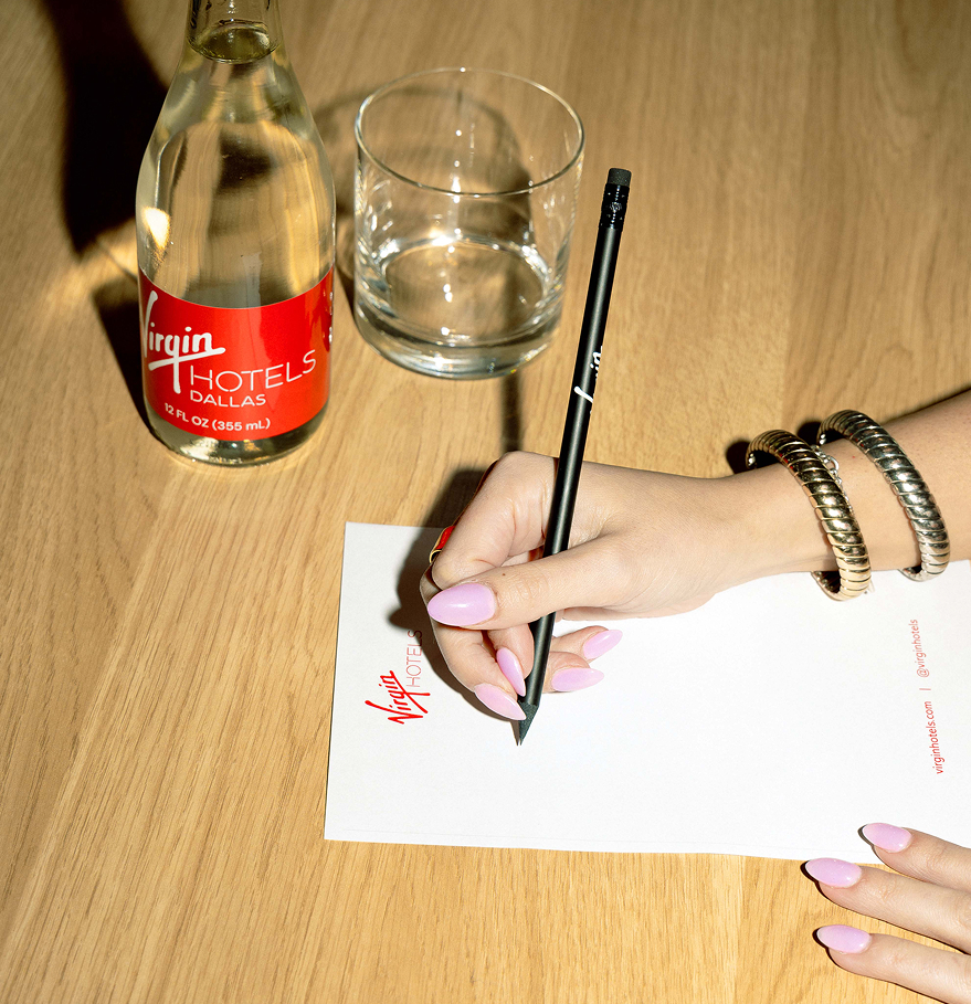 a hand writing on a piece of paper