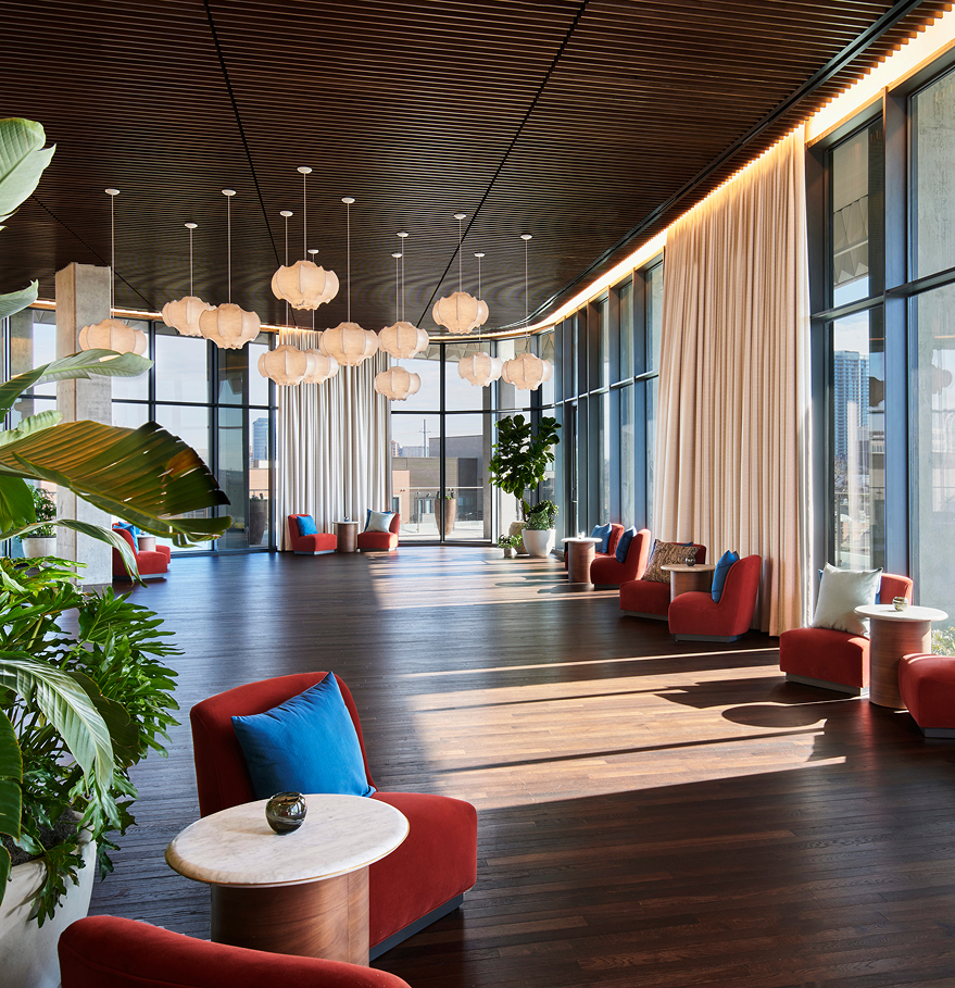 a room with chairs and tables and plants