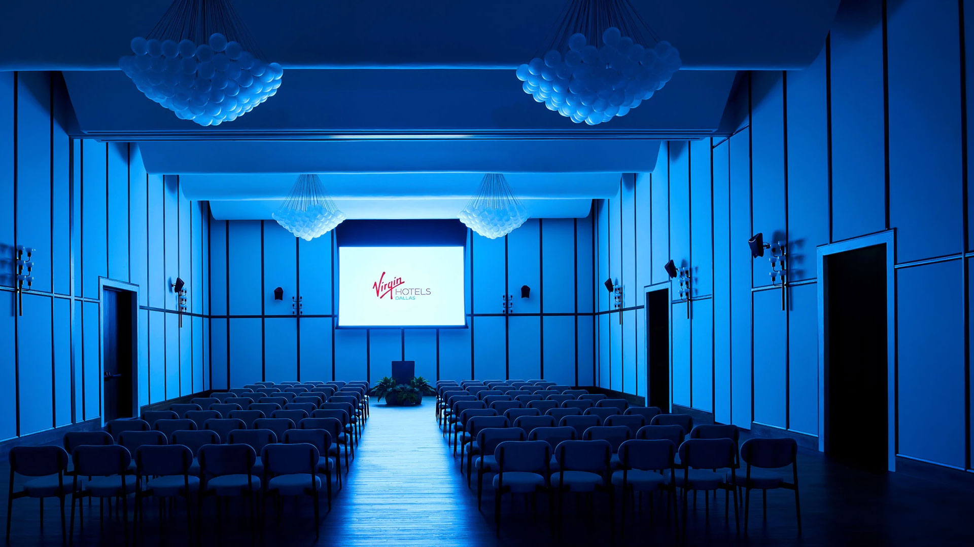 a room with chairs and a projector screen