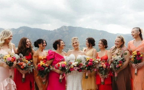 a group of women in dresses holding flowers