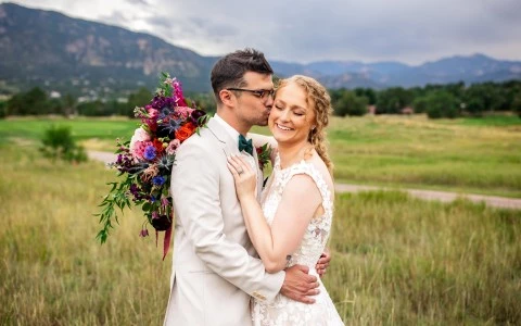 a man and woman kissing in a field