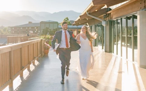 a man and woman running on a walkway