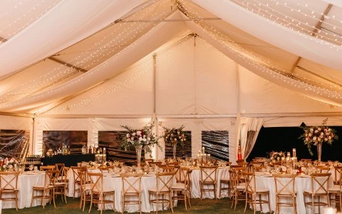 a tent with tables and chairs