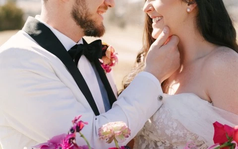 a man and woman smiling with flowers