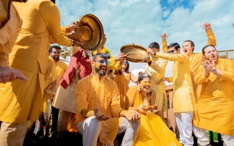 a group of people in yellow dresses pouring water