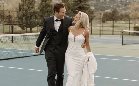 a man and woman walking on a tennis court