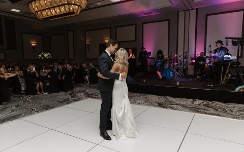 a man and woman dancing on a white floor
