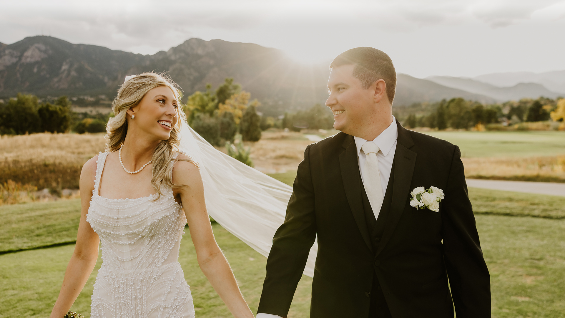 a man and woman holding hands and smiling