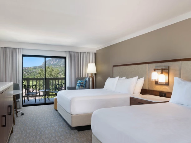 a room with two beds and a balcony