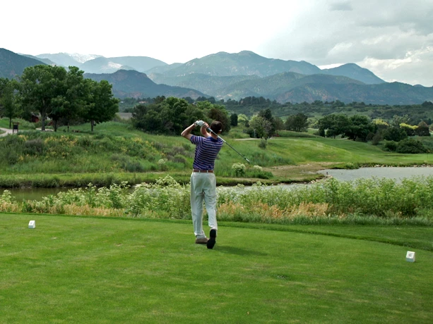 a man swinging a golf club