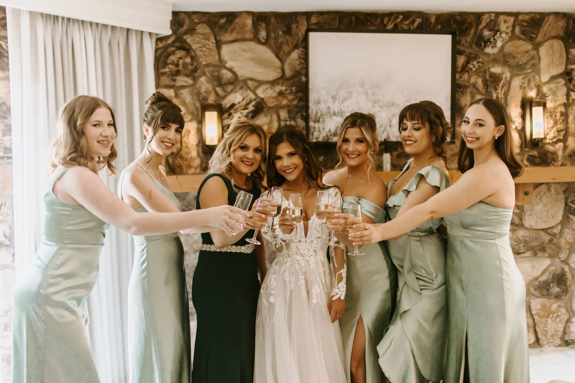 a group of women in dresses holding wine glasses