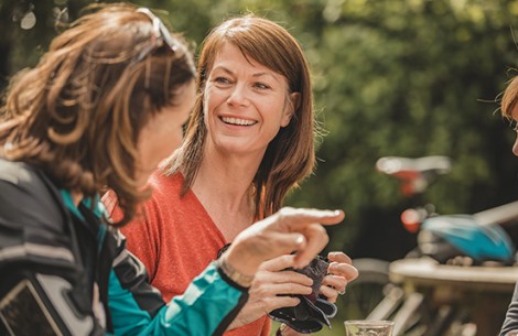 a woman smiling and pointing at something