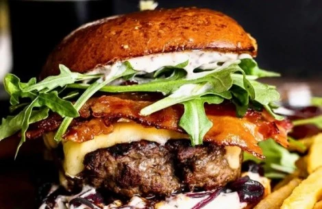 a burger with bacon and cheese