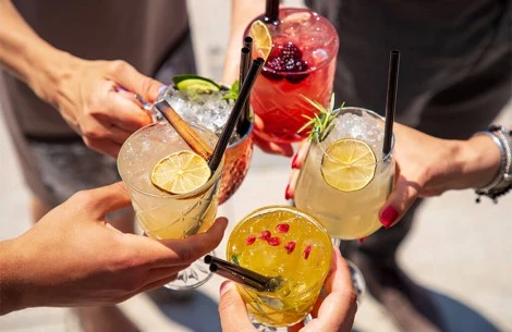 a group of hands holding drinks