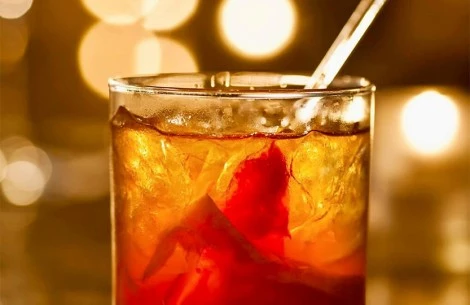 a glass with a drink and a straw