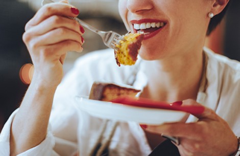 a woman eating a piece of cake