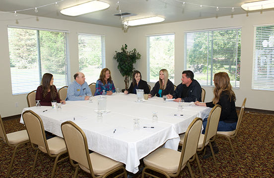 a group of people sitting around a table
