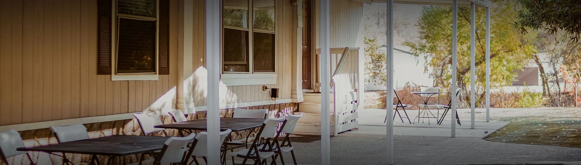 a table and chairs outside of a house