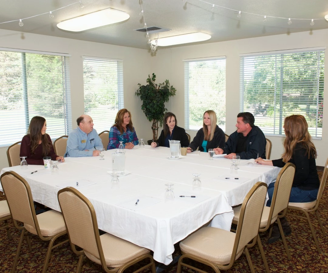 a group of people sitting around a table