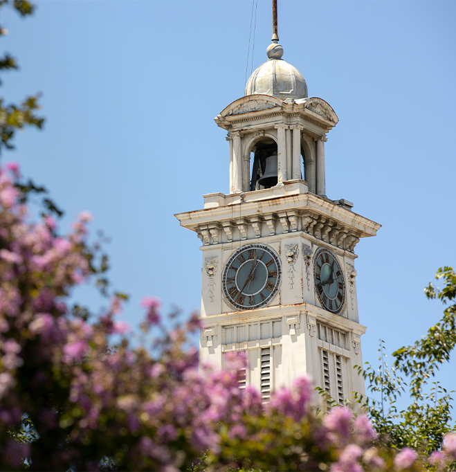 a clock tower with a cross on top