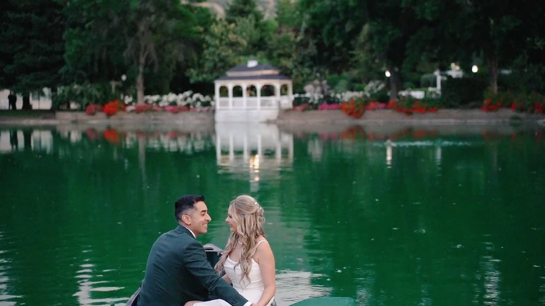 a man and woman sitting on a boat in a lake