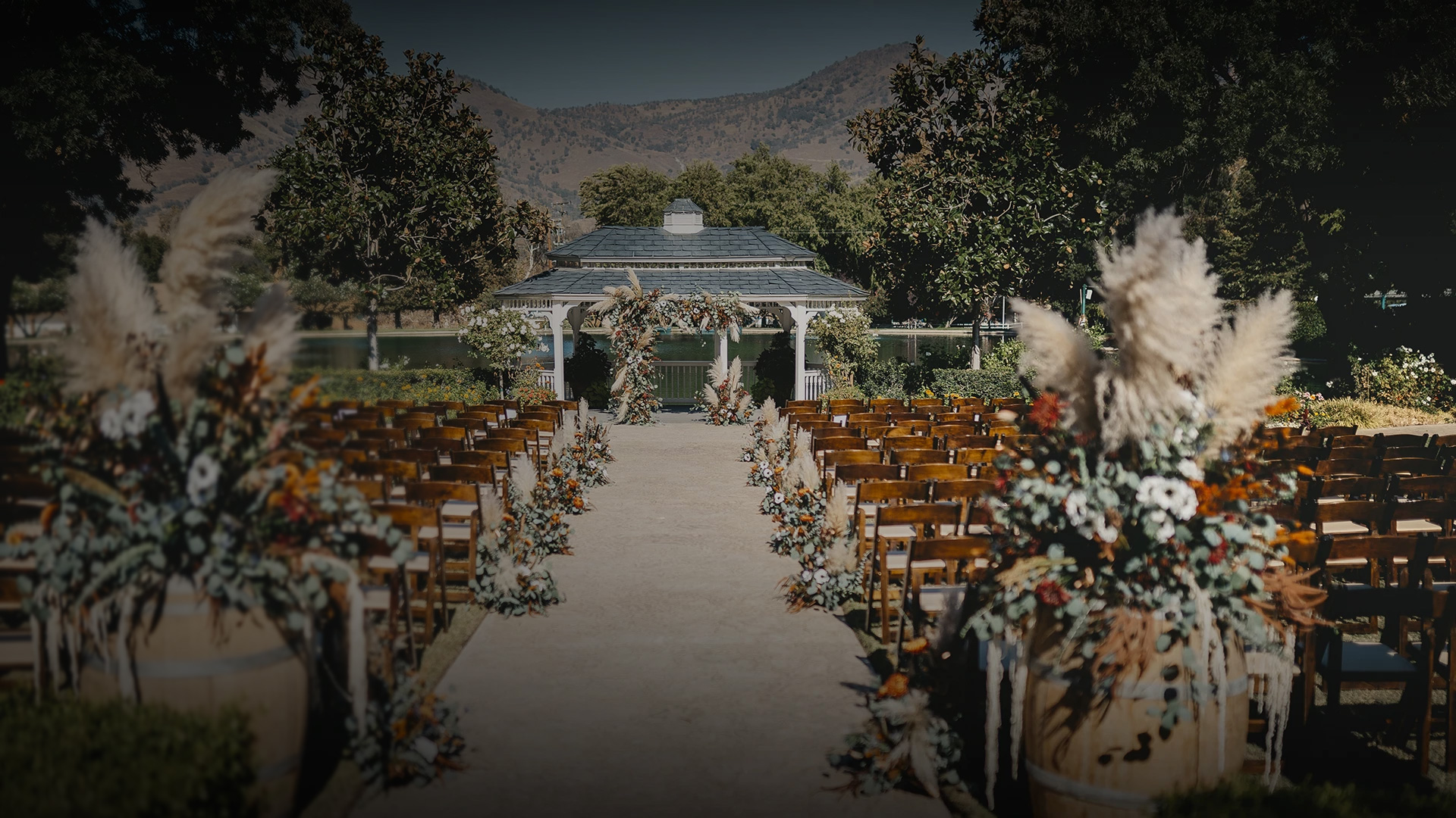 a wedding venue with chairs and trees