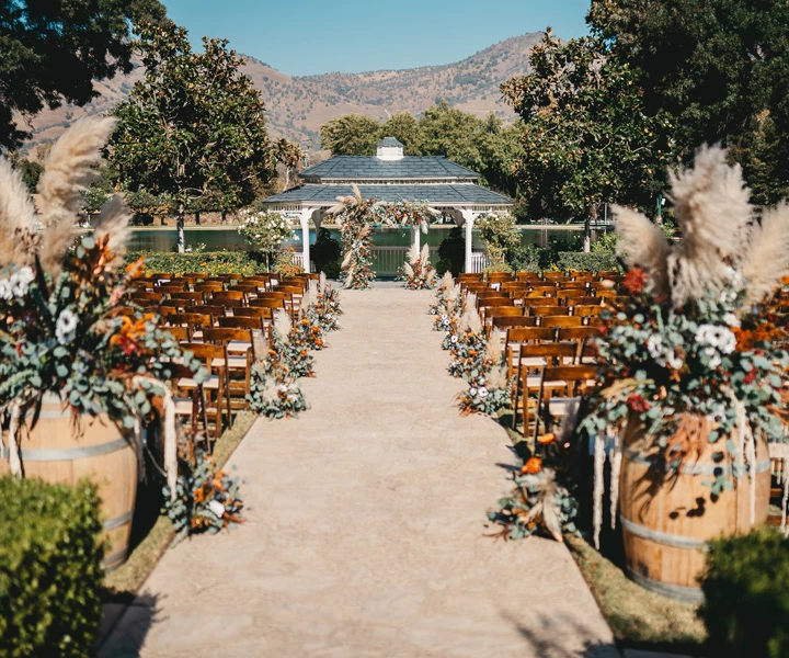 a wedding ceremony with chairs and trees