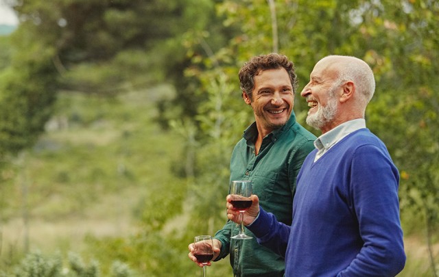 two men holding wine glasses