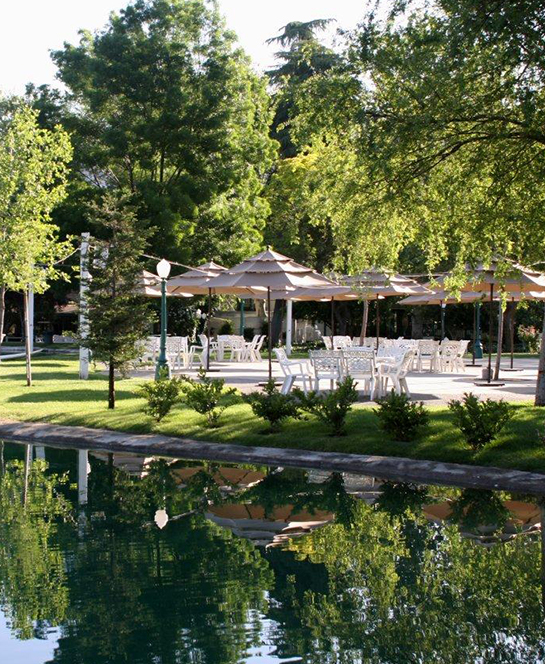 a pool with umbrellas and tables and chairs