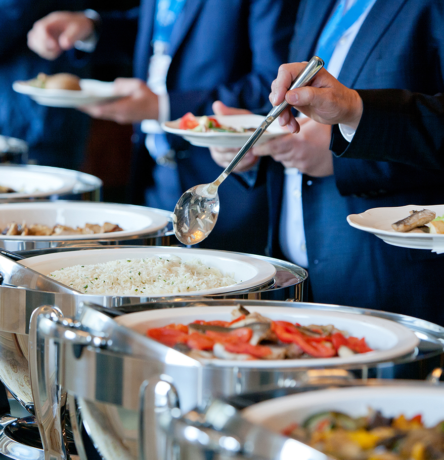 a group of people in suits serving food