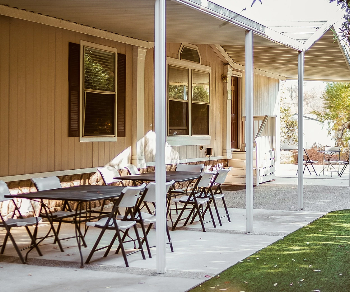 a table and chairs on a porch