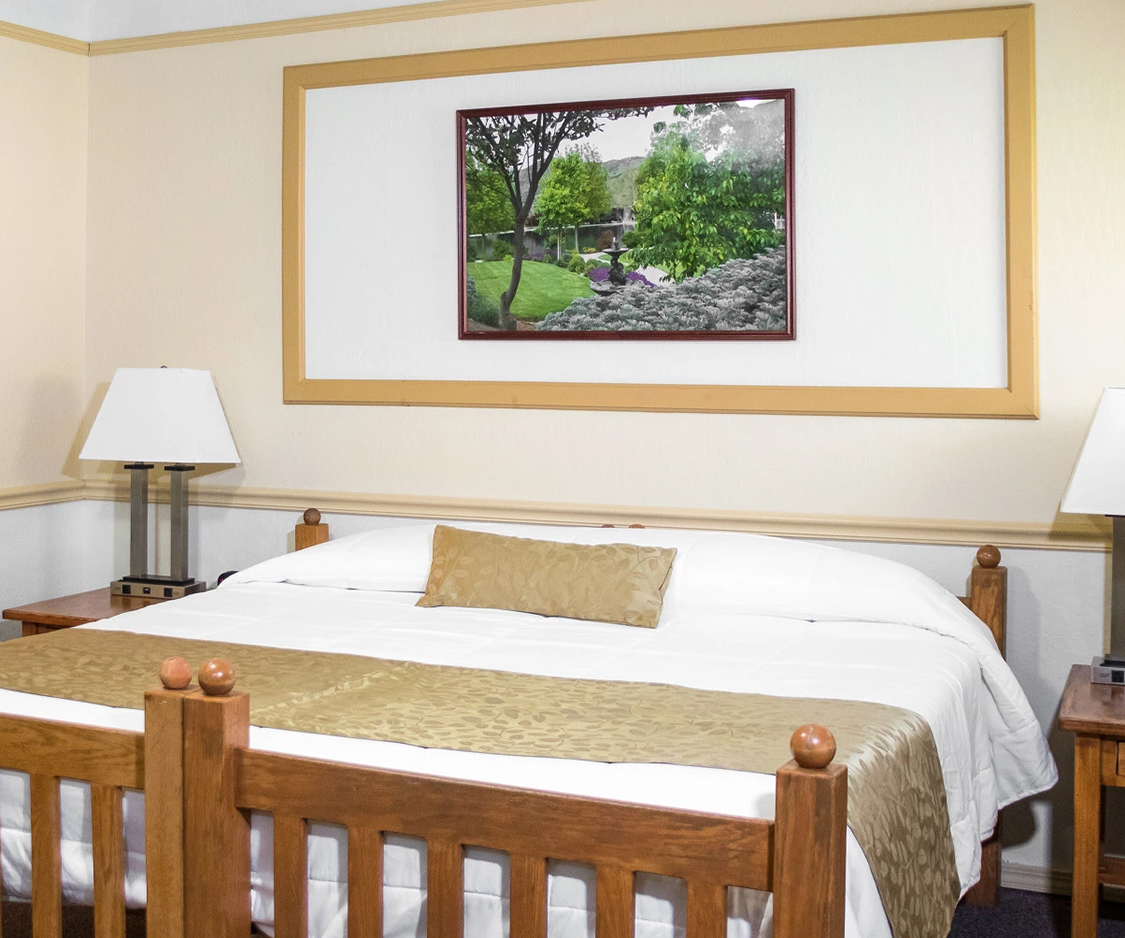 a bed with a picture on the wall
