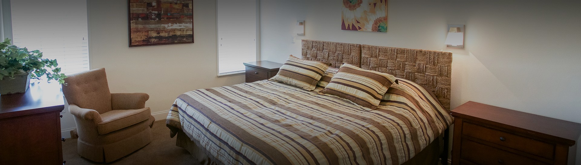 a bed with striped bedding and pillows