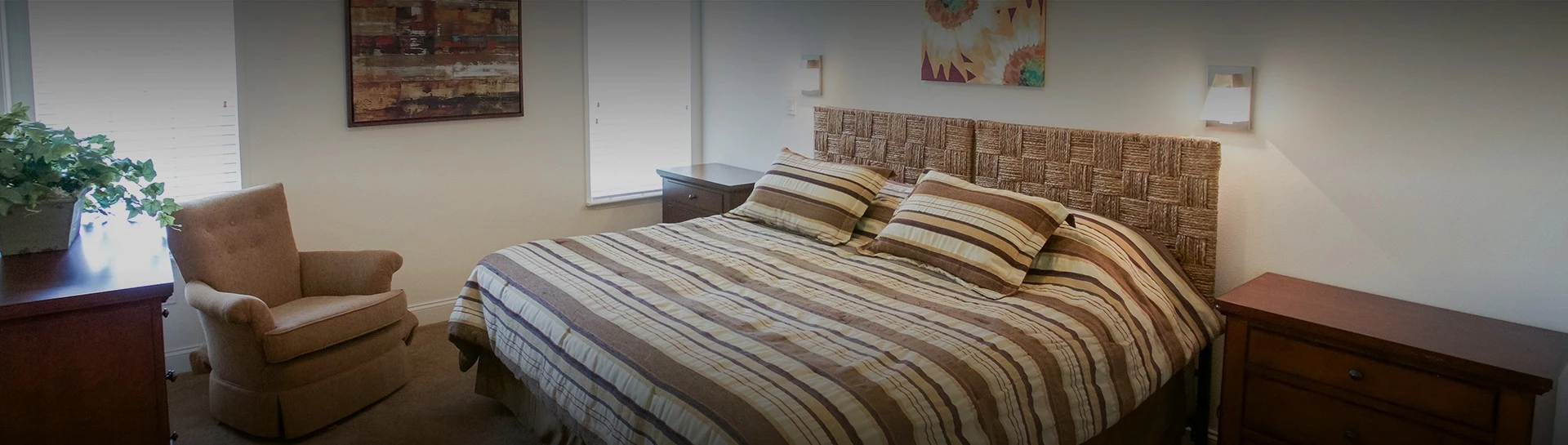 a bed with striped bedding and pillows