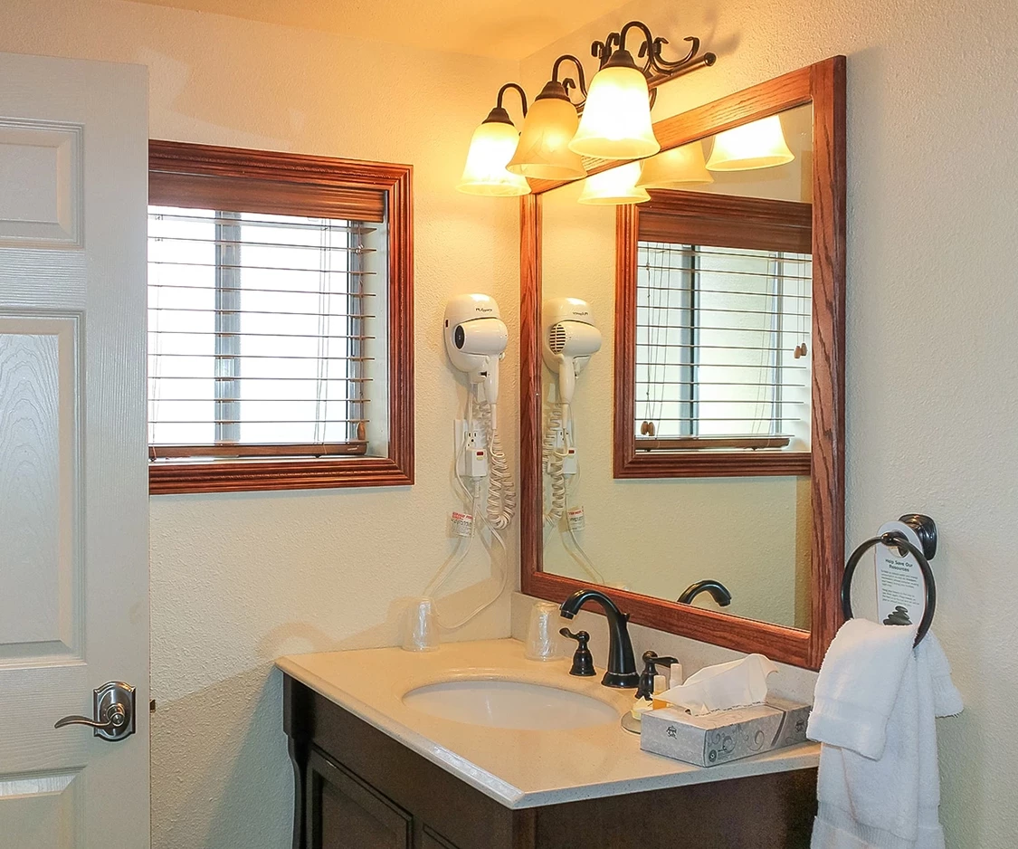 a bathroom with a mirror and sink