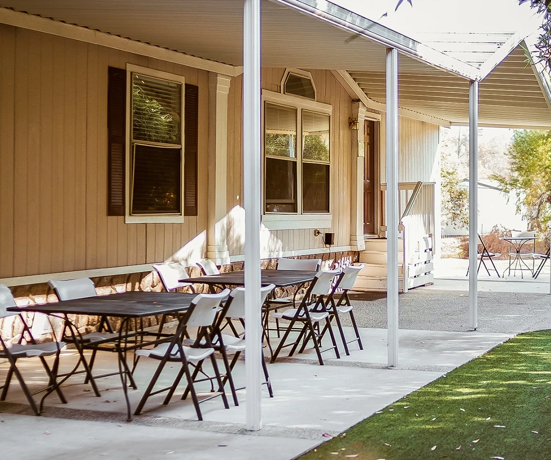 a table and chairs on a porch