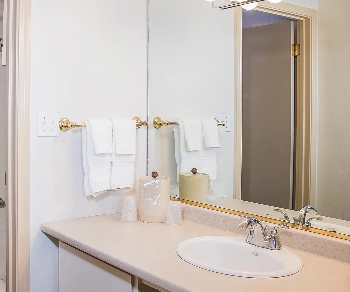 a bathroom with a mirror and sink